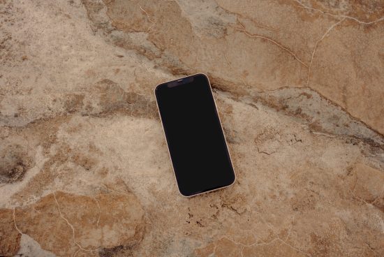 Smartphone mockup on textured rock surface for product display, ideal for designers showcasing apps and designs in a natural setting.
